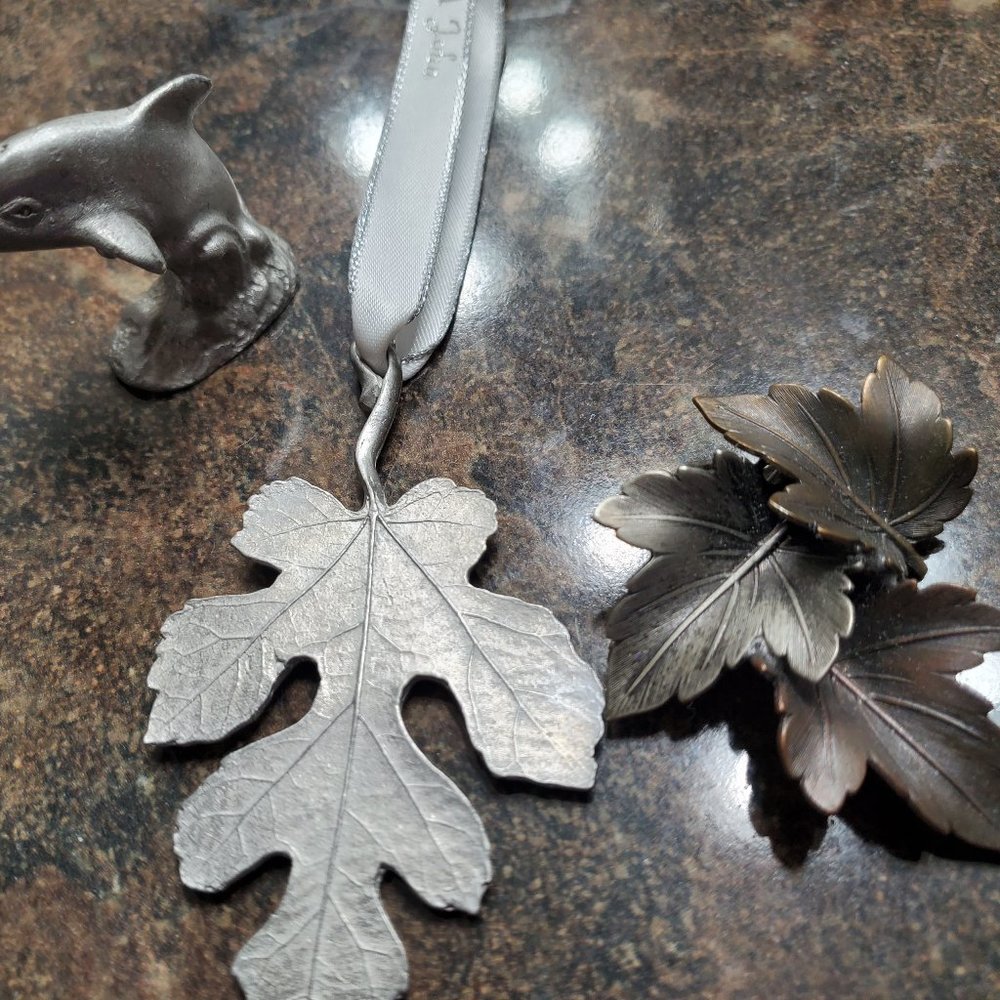 Pewter dolphin, leaf lapel pin and leaf hanging ornament.